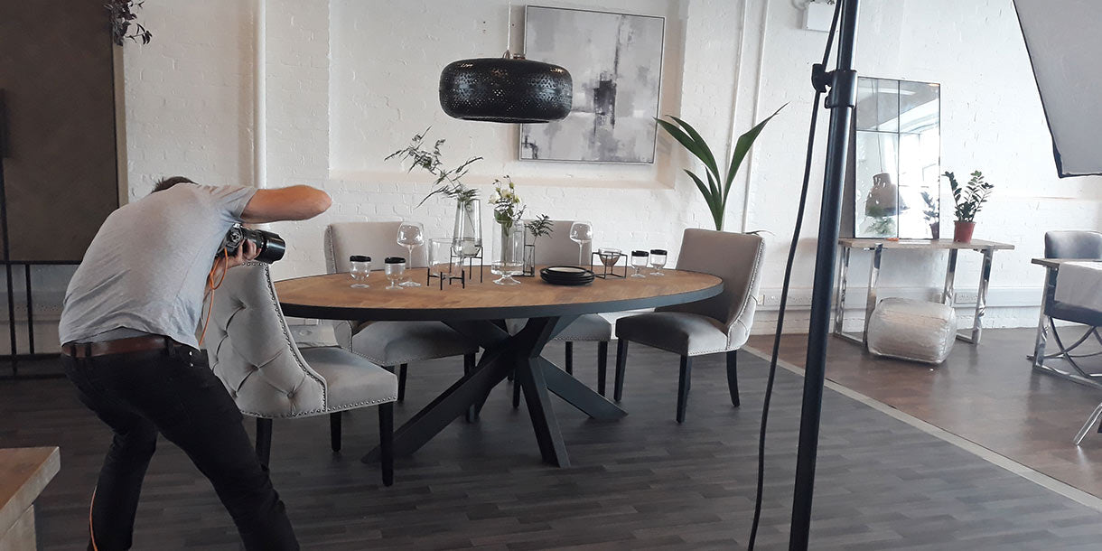 A photographer taking a close up photo of our Sussex Oak Parquet Industrial Oval Dining Table