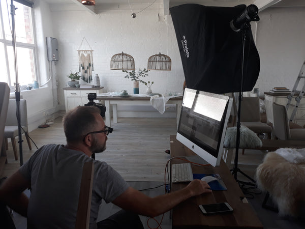 Our photographer inspecting the pictures just snapped of our Dorset Reclaimed Wood Extending Table