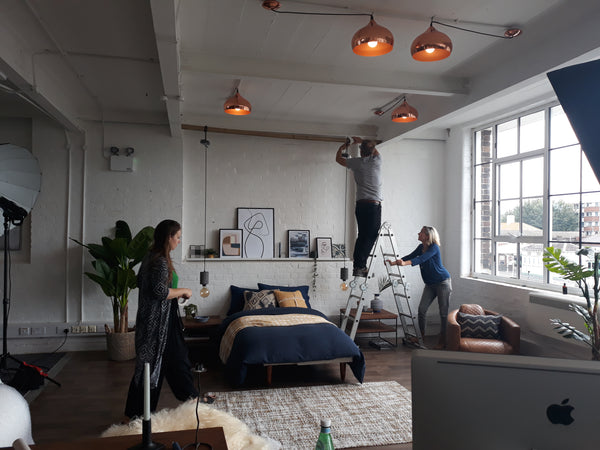 Behind the scenes of our photoshoot where pendants are adjusted.