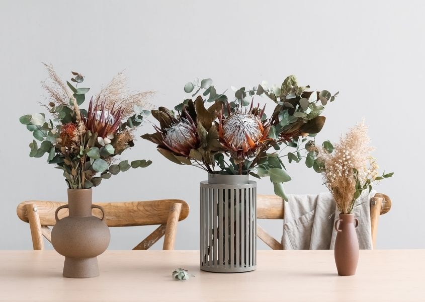 dried flowers display in stone vases