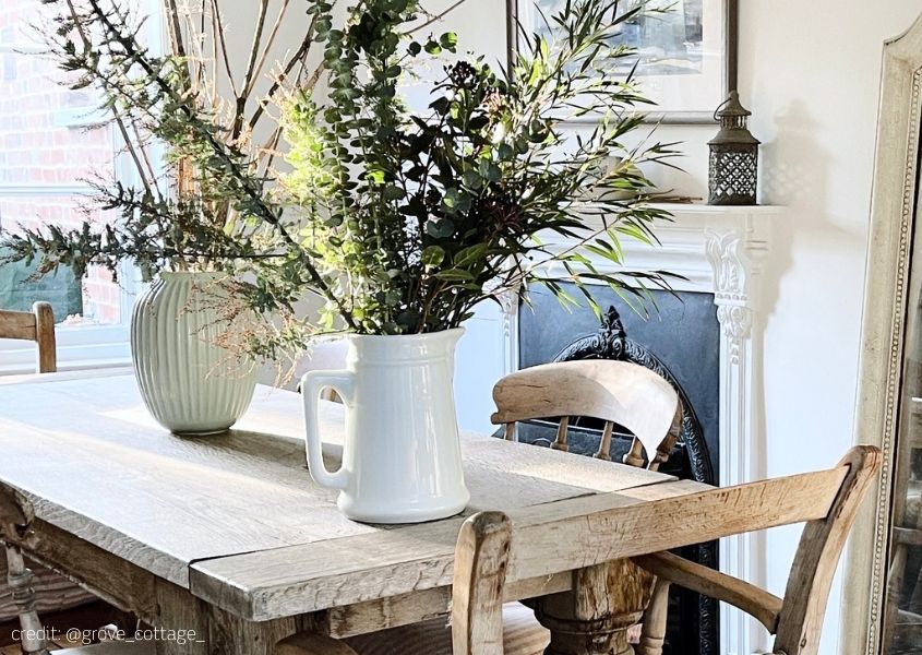 large display of flowers in vases on rustic dining table