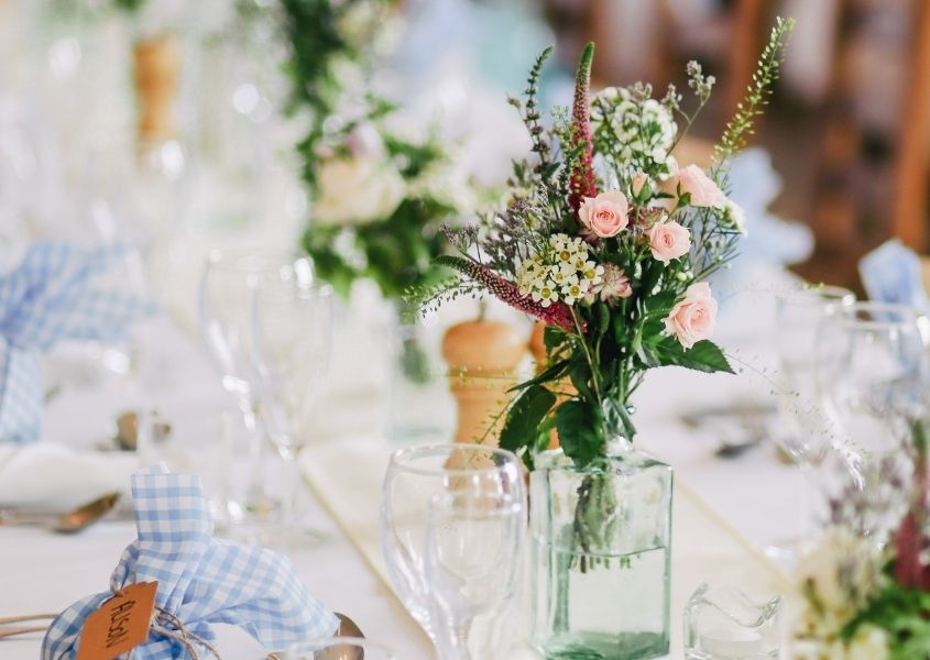 spring flowers in jars on large dining table
