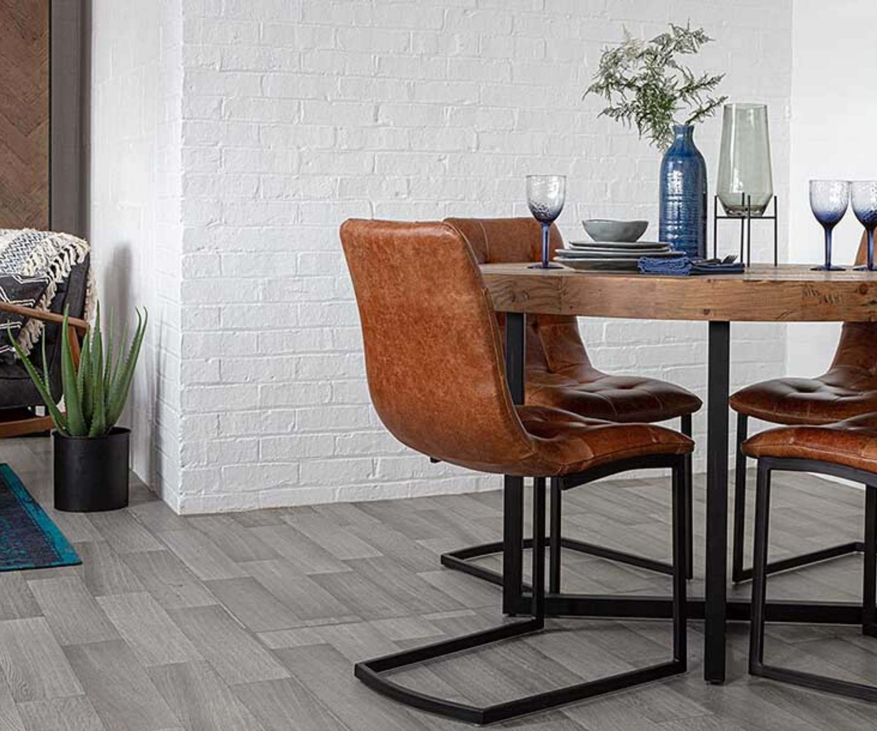 wood round table with faux brown leather chairs