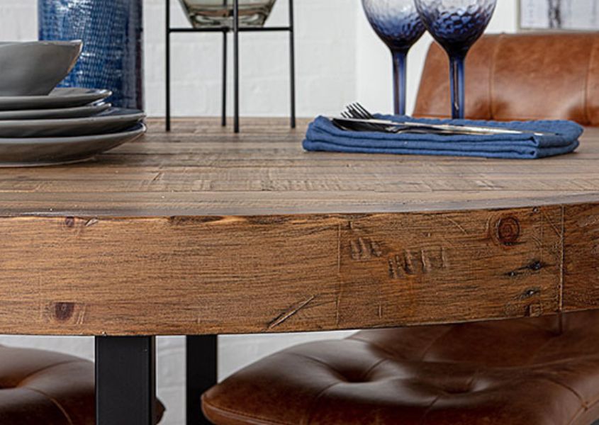 close up of round reclaimed wood dining table