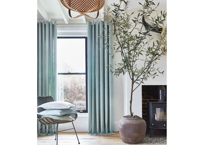 Large tree in next to round dining table