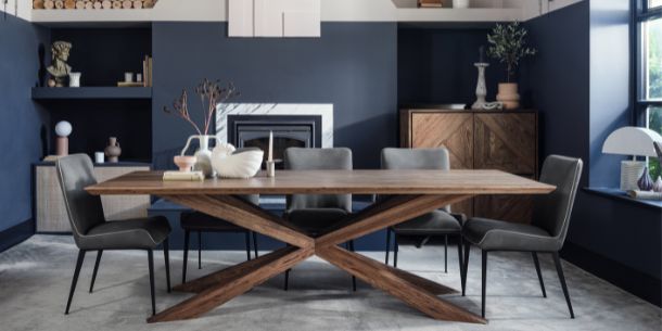 solid oak dining table with wooden spider leg and grey faux leather dining chairs