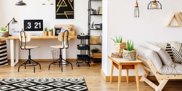 modern office desk in open plan living room with wooden office chairs