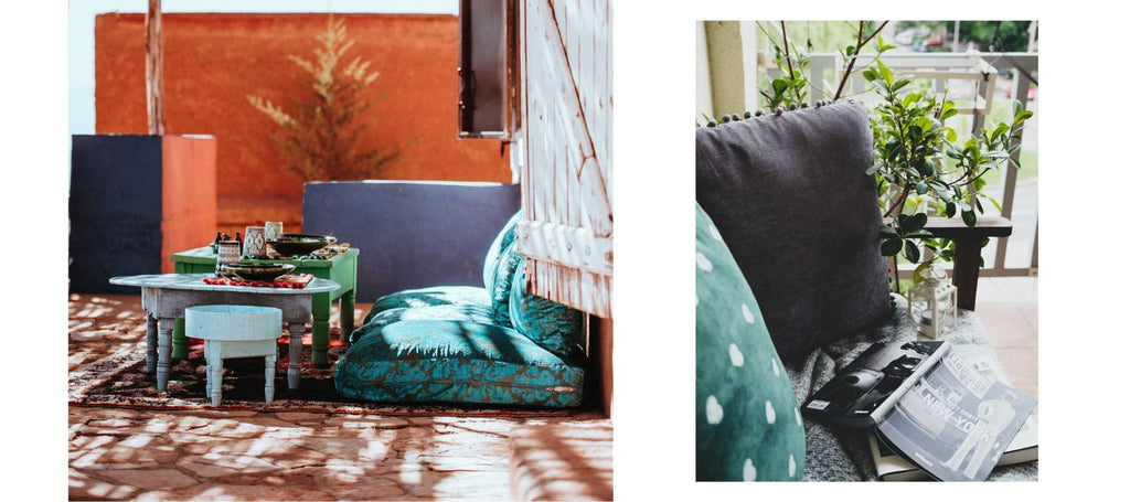 Large blue floor cushions with orange terracotta wall