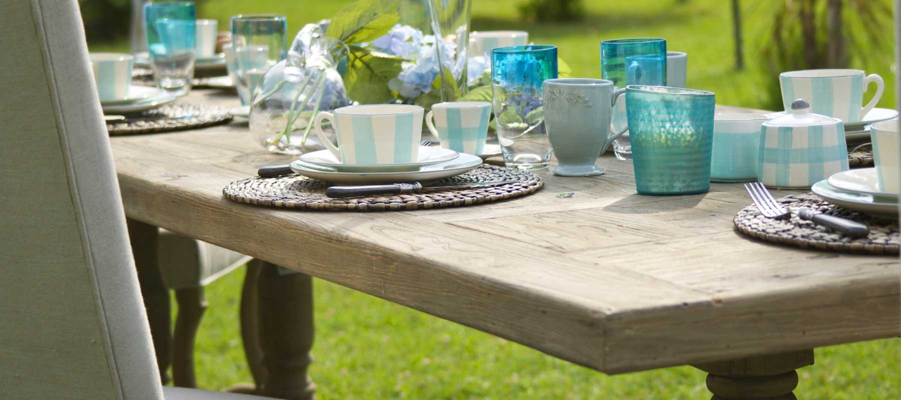 Reclaimed wood dining table with blue glasses