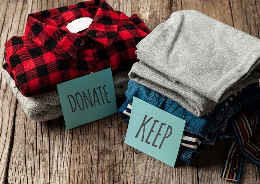 pile of clothes to keep or donate for how to declutter your wardrobe responsibly blog