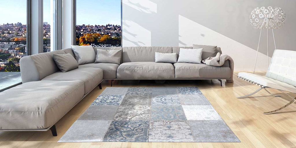 Louis de Poortere Vintage Patchwork Bruges Blue Rug in living room with sofa