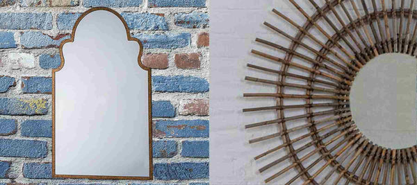 Gold mirror against brick wall and round bamboo mirror