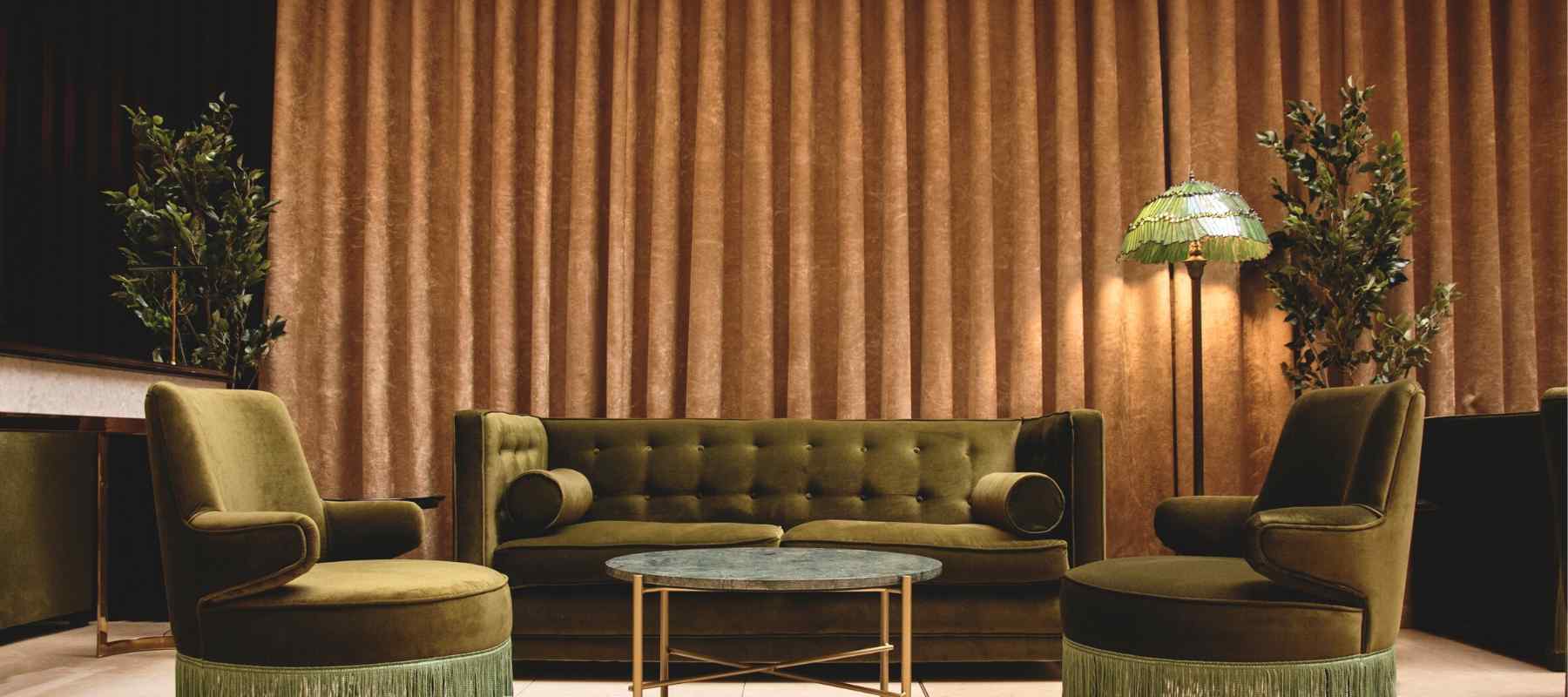 Lounge bar with green velvet sofa and armchairs