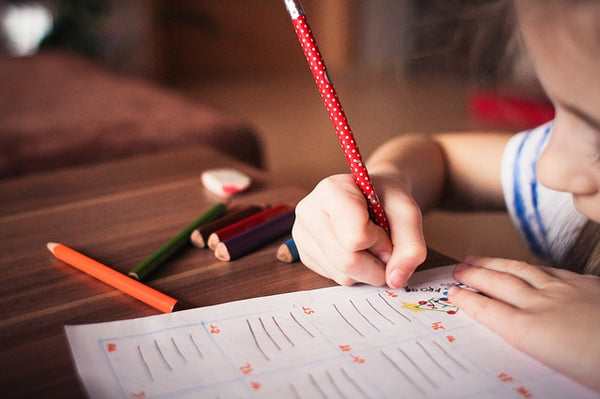 Child Drawing on Reclaimed Wood Table