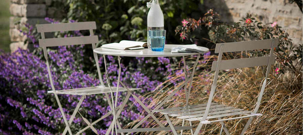 Metal bistro table and chairs in clay