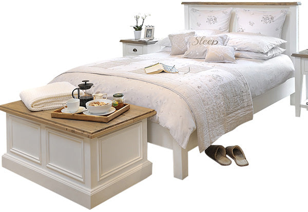 Reclaimed wood bed painted white with a similar blanket box and bedding