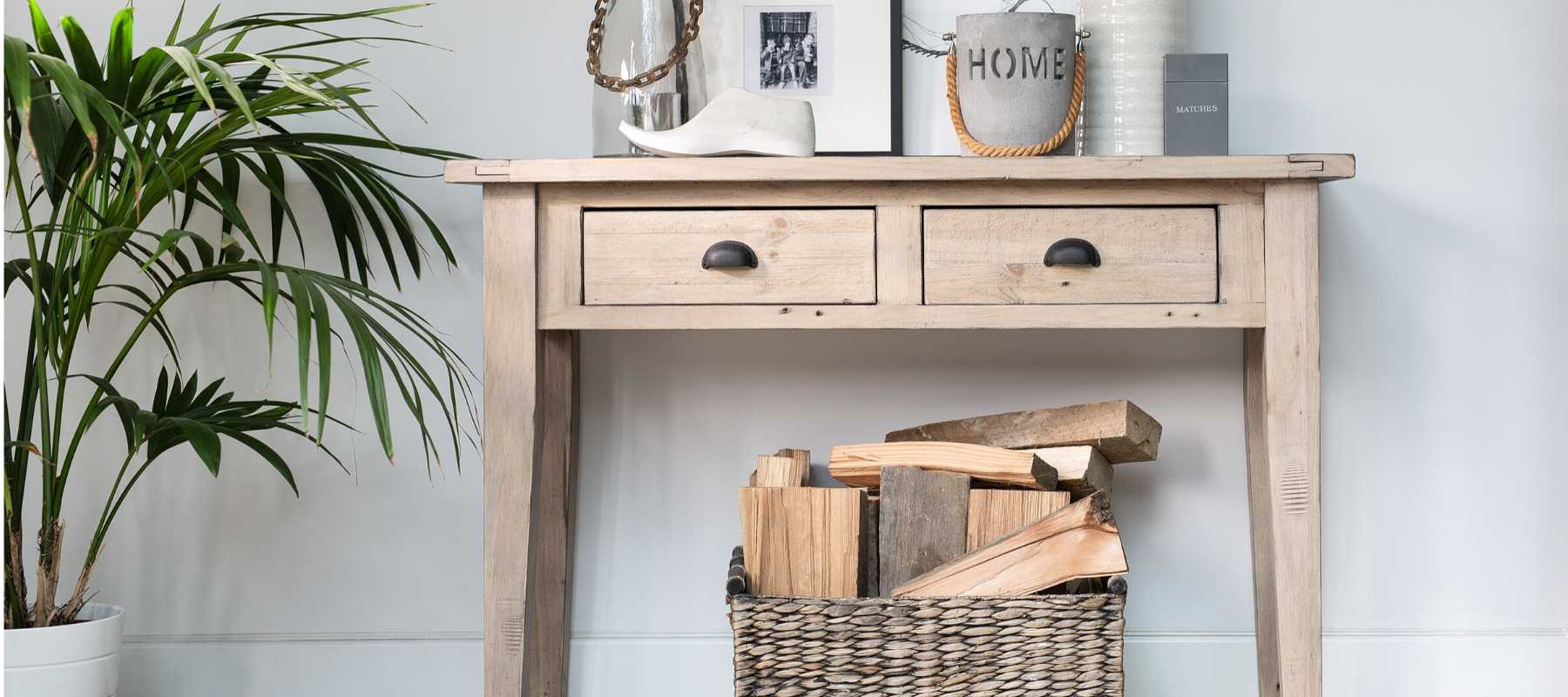 Reclaimed wood console table with basket of logs 