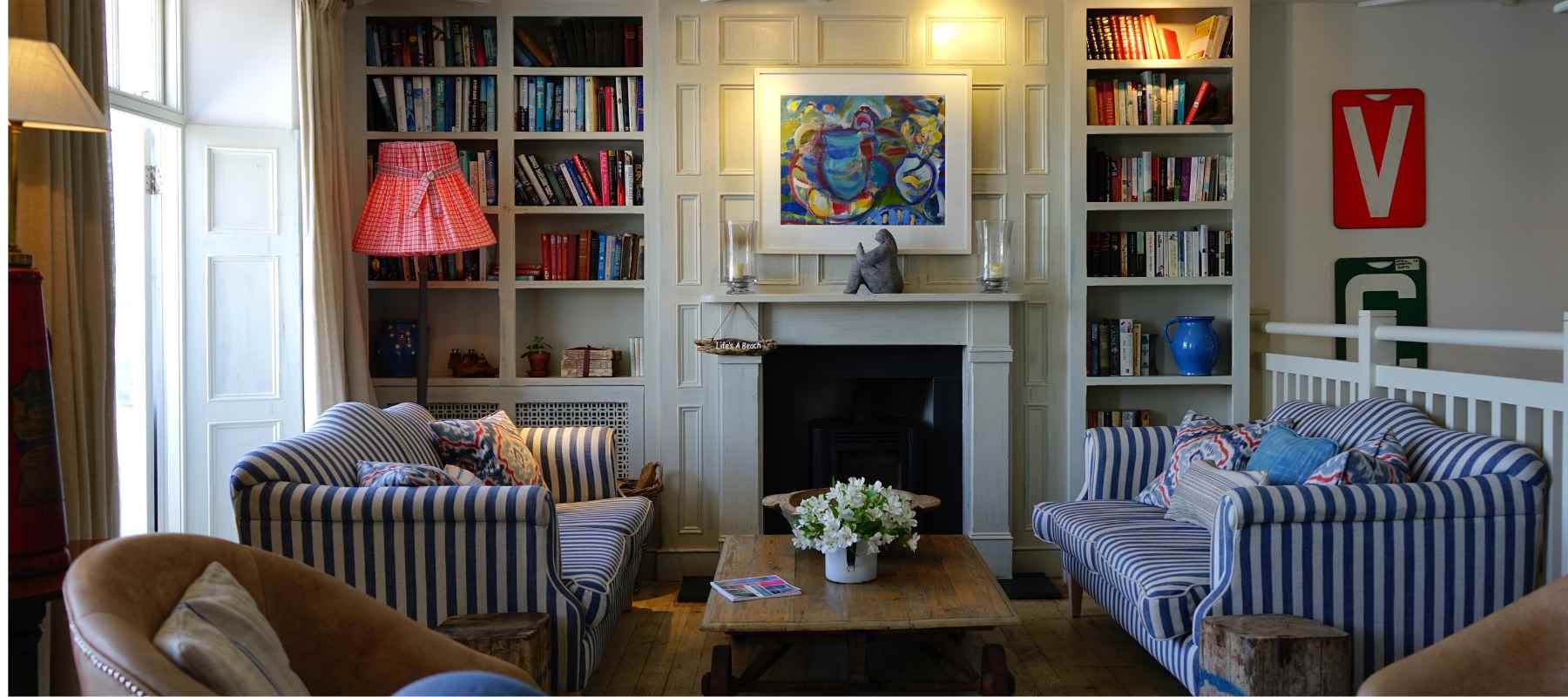 Two blue and white striped sofas facing each other