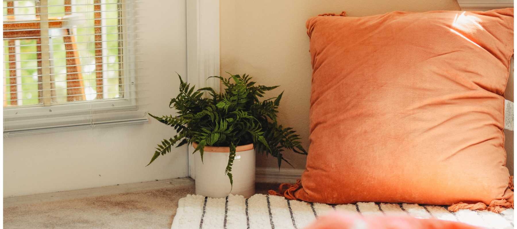 Large orange cushion on the floor