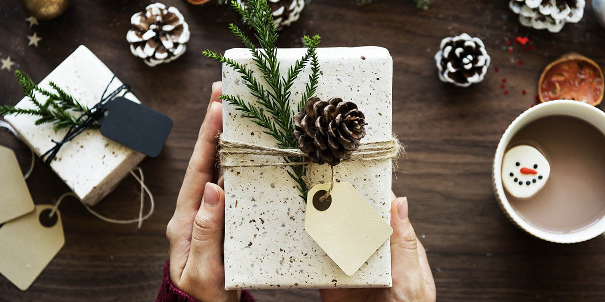 A Christmas gift wrapped in white paper with string