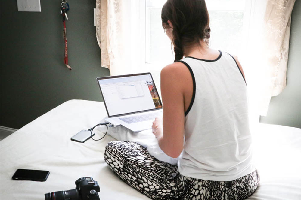 Woman Sitting on Bed in Bedroom