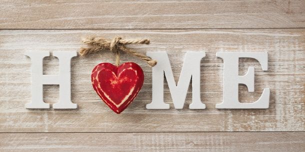 Wooden letters spelling home with a red heart for letter o