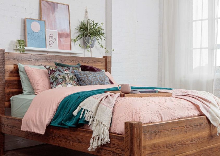 solid wood bed with pastel pink colours