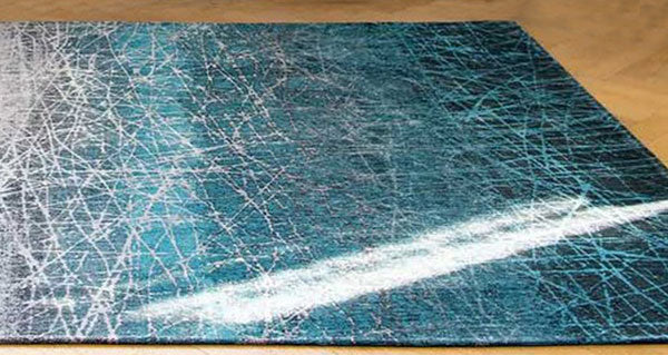 A Louis De Poortere rug in a blue ombre pattern