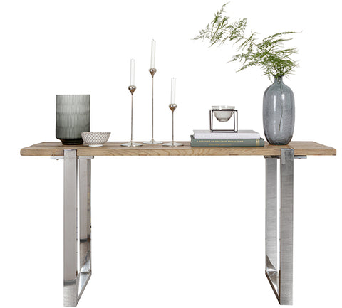 A reclaimed elm console table with candles and vases on top