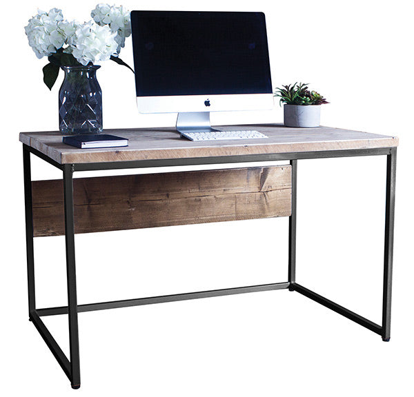 An industrial style desk made of reclaimed wood with a computer on top and plants