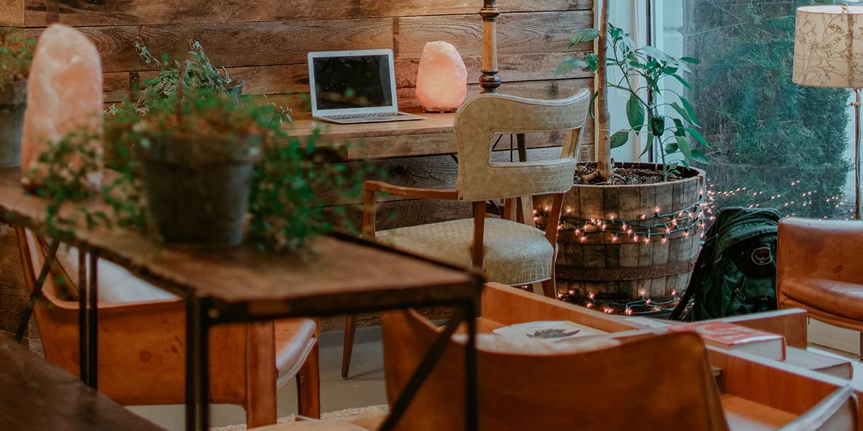 A rustic living room with a wooden desk and upholstered chair