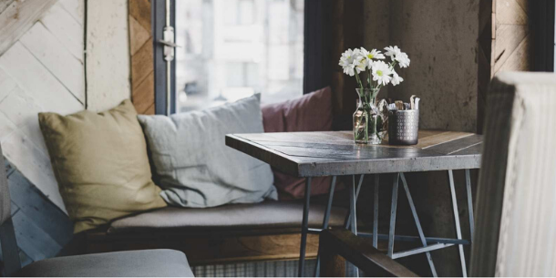 Small dark wooden table with linen cushions