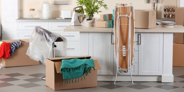 kitchen with moving in boxes and ironing board