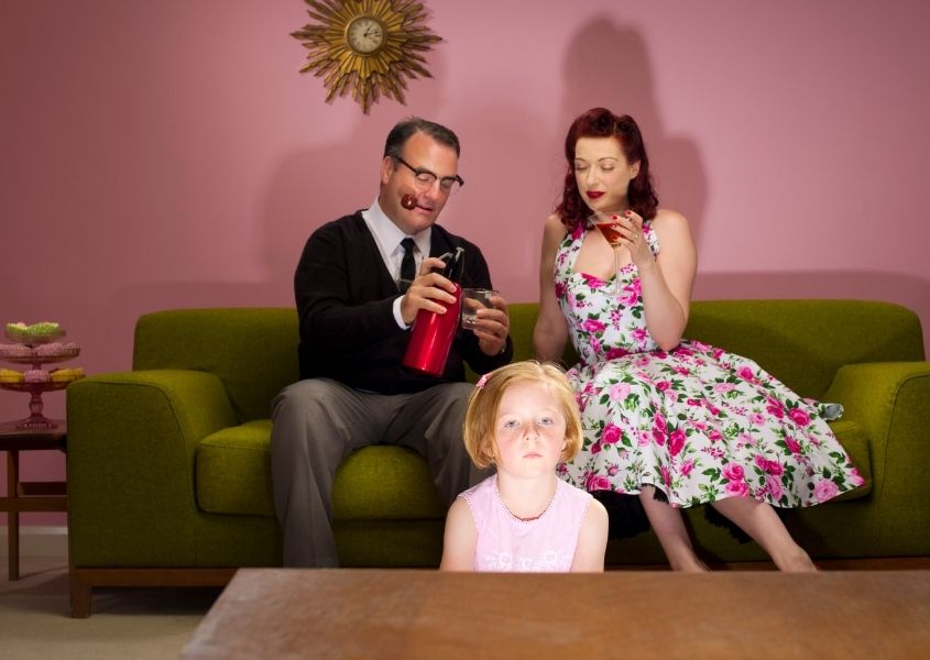 Family sat of green sofa for top 1950's interior style and design trends blog