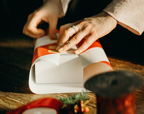 A person wrapping a Christmas gift