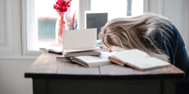Blonde woman asleep on desk