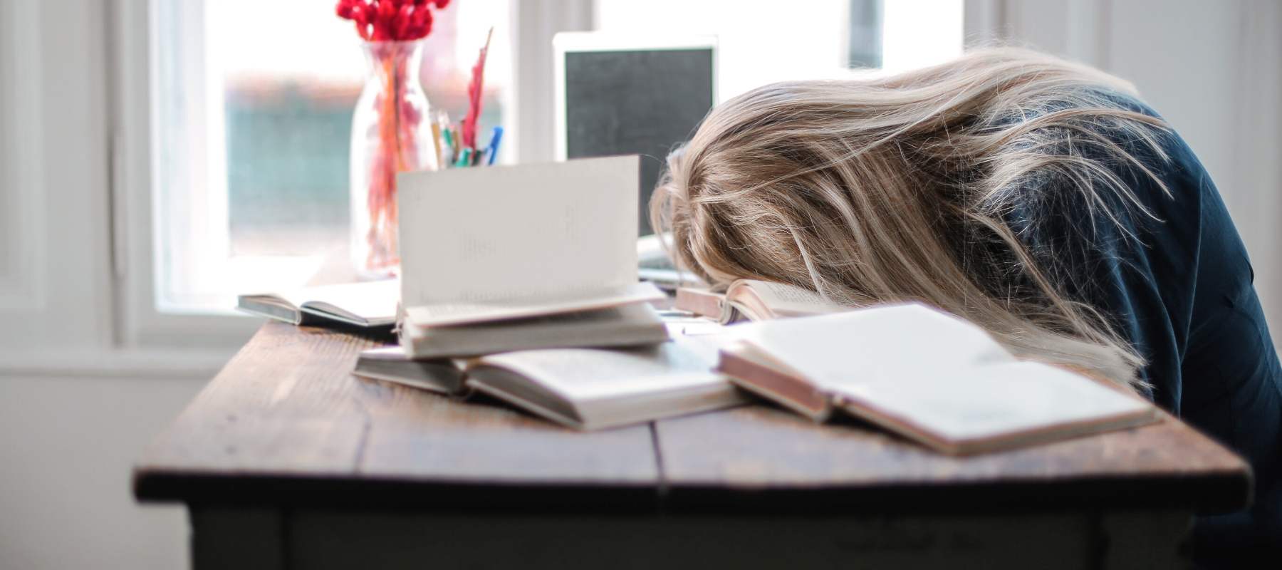 Girl asleep on wooden desk