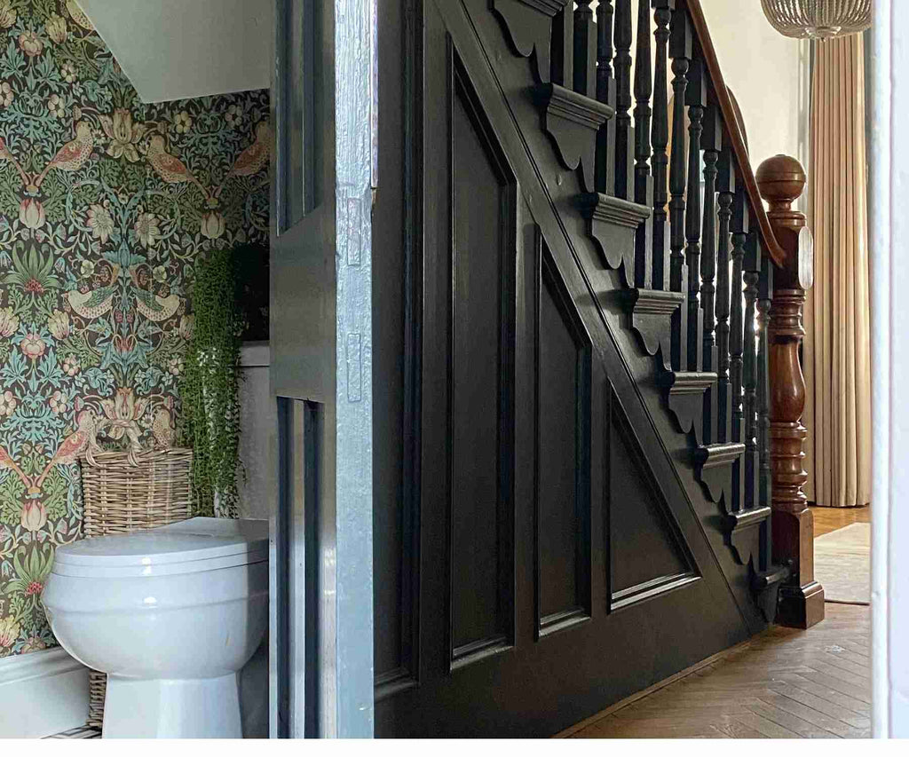 Under the stairs cloakroom with green patterned wallpaper