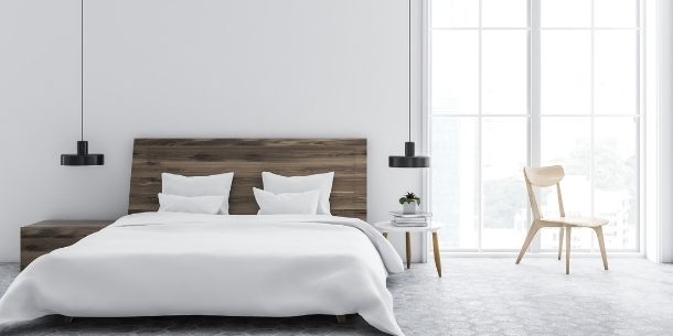 White bedroom with king size wooden bed frame