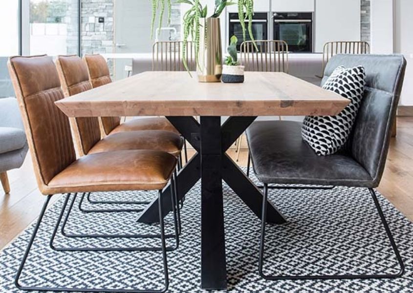 Spider leg dining table with grey faux leather dining bench with back