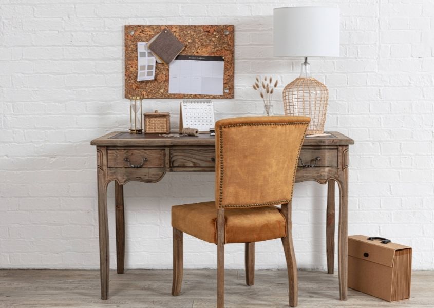 reclaimed wood writing desk with orange velvet chair and cardboard filing case