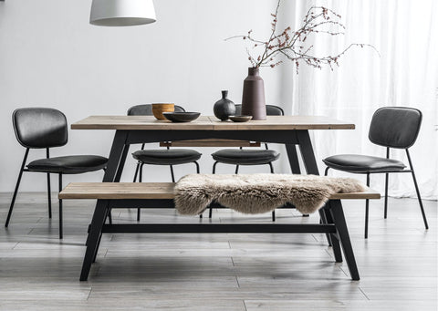 reclaimed wood dining table with wooden dining bench and black faux leather dining chairs