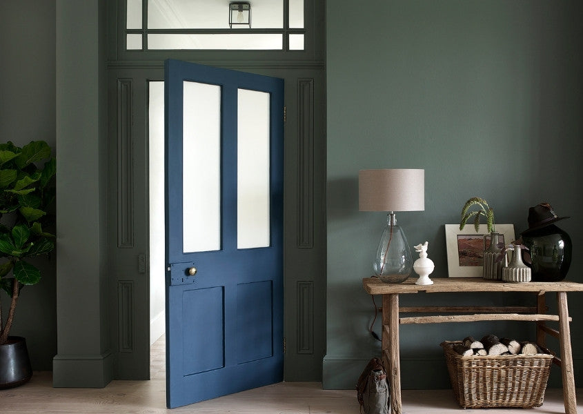 rustic wooden console table with green painted walls