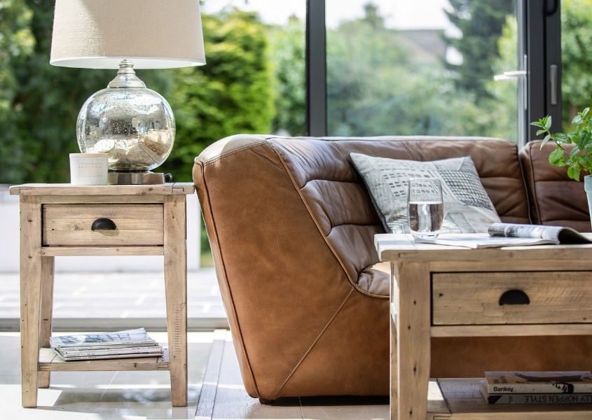 rustic coffee table next to brown leather sofa wooden side table