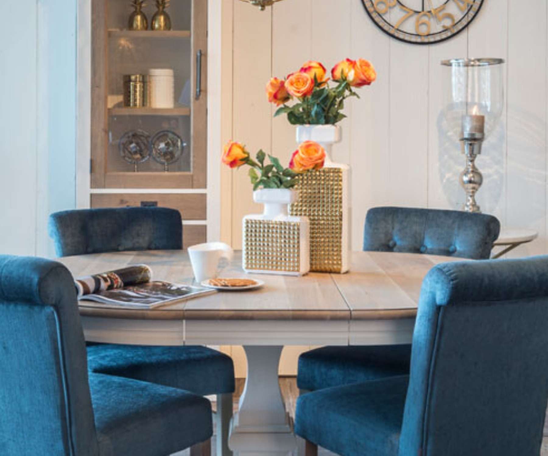 extended round dining table with blue velvet chairs