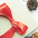 Close up of white box with red ribbon with cookies