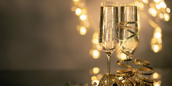 Two champagne flutes with gold confetti