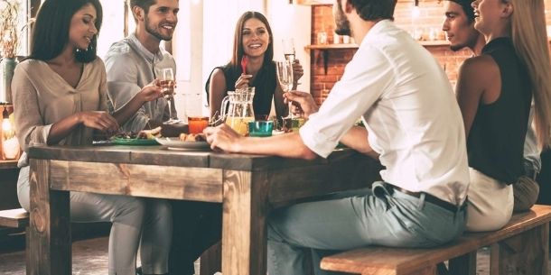 Friends gathered around a rustic dining table
