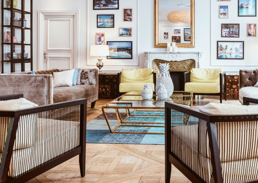 living room with gold coffee table and wooden armchairs