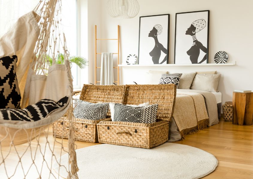 boho style bedroom with solid wood bed frame and wicker blanket box